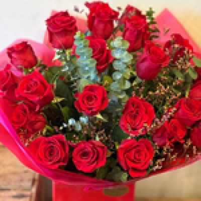Super Luxury Surprise - 24 luxury red roses hand tied with high quality green and filler flowers. Presented in a bubble of water in a presentation box.