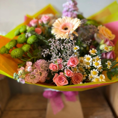 Strawberries and Peaches - Hand tied bouquet of pinks and peachy flowers in a summer selection. Presented in a bubble of water.